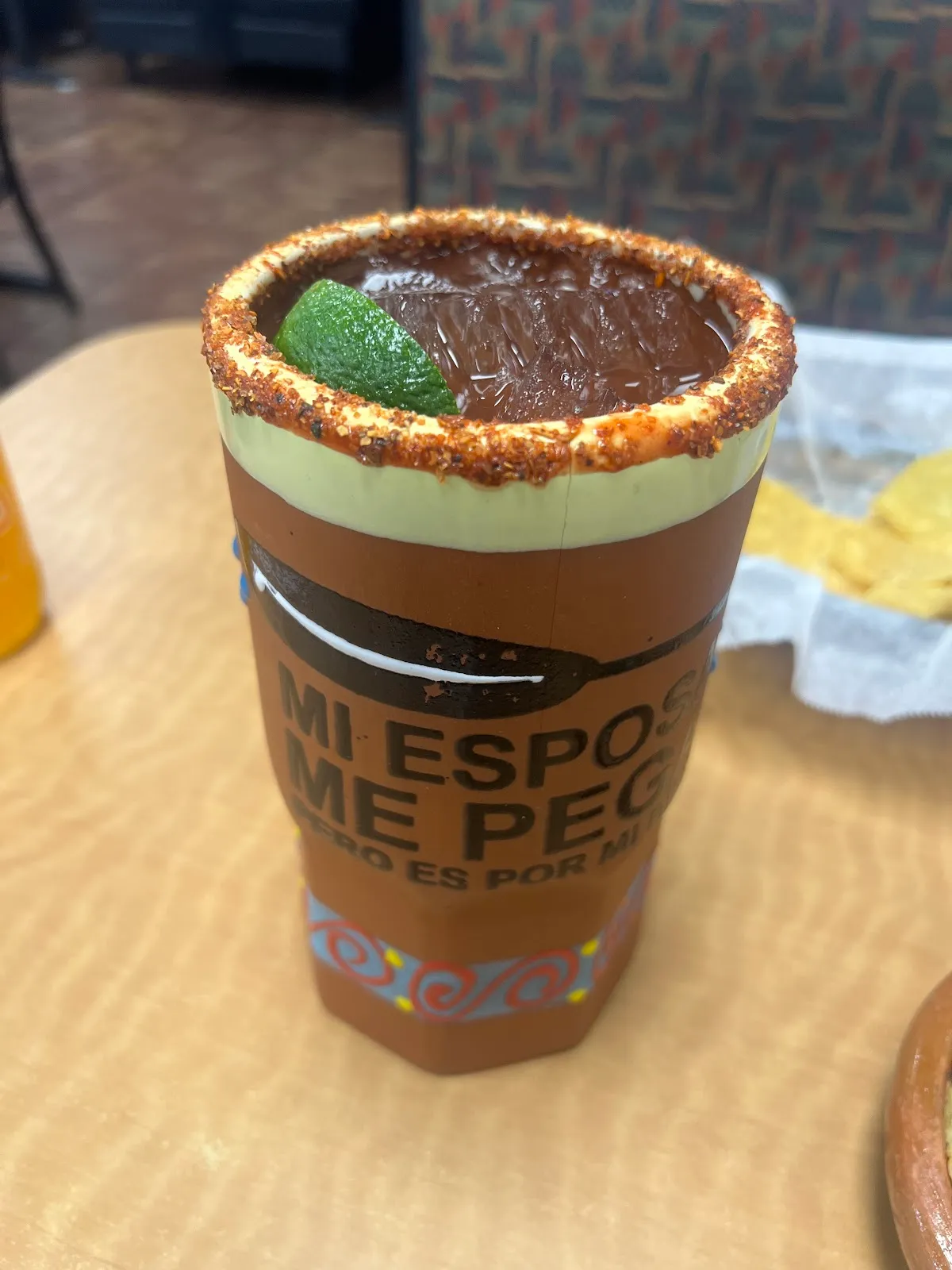 A plate of enchiladas or smothered burritos with red sauce, rice, and beans
